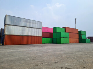 stacks of colorful containers in a container yard near the port. container depot in Indonesia....