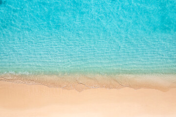 Stunning top view on coast waves on beach aerial view. Calm crystal clear water. Stunning summer...