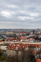 Fototapeta na wymiar Panoramic view of the medieval city Prague during winter. You can the Charles bridge and skycrapers in the distance. The wather was cloudy