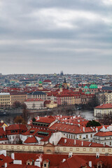 Fototapeta premium Panoramic view of the medieval city Prague during winter. You can the Charles bridge and skycrapers in the distance. The wather was cloudy