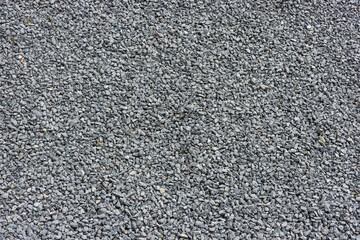 Black pebbles rubble background top view