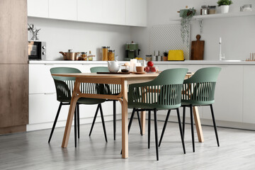 Interior of modern kitchen with table served for breakfast
