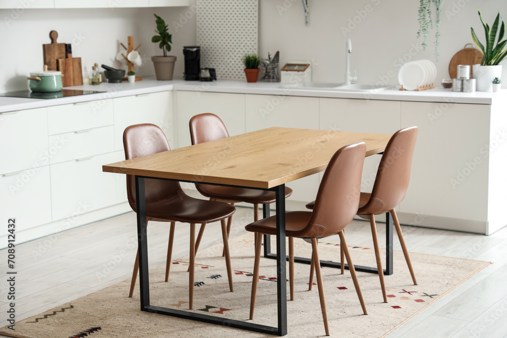 Wall mural clean wooden table in interior of modern kitchen