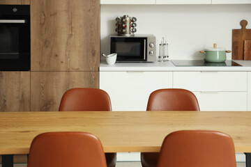 Clean wooden table in interior of modern kitchen