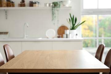 Clean wooden table in interior of modern kitchen