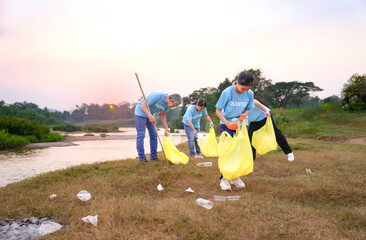 group of volunteers in blue t-shirt collecting garbage and sorting plastic waste, voluntary family...