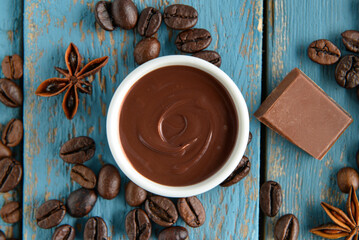 Composition with tasty melted chocolate on blue wooden background