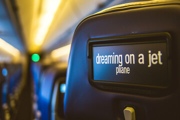 Obraz premium Interior of an airplane with a sign on the screen. Selective focus. Jet.