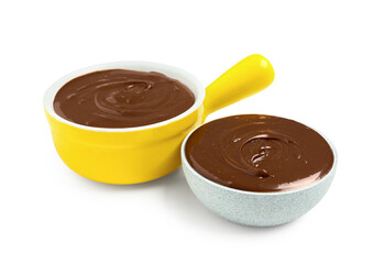 Bowls of tasty melted chocolate on white background