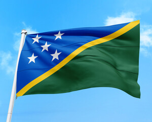 Solomon Islands flag fluttering in the wind on sky.