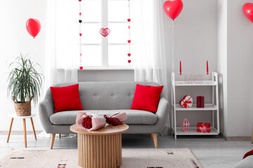 Interior of modern living room bouquet of roses on coffee table and decorations for Valentine's Day celebration