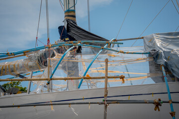 Motor yacht moored for repairs and service in dry dock