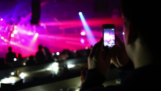 Man shoots laser show and silhouettes of people by phone
