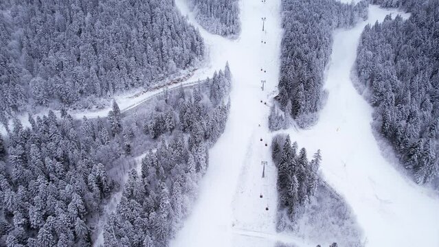 Winter ski resort, ski slope, lift cabins and gondola of aerial view