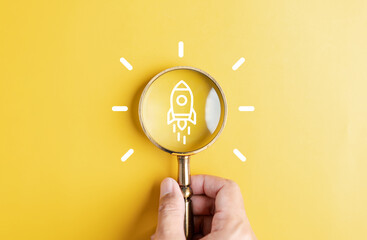 Magnifier glass focus to rocket launch objective with idea creative light bulb icon. planning...