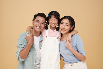 Portrait happy smiling Asian family hugging and love together isolated on nude color background.