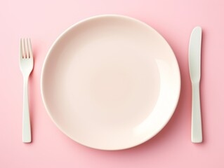 White Plate With Ceramic Fork and Knife on Pink Background. Copy space.