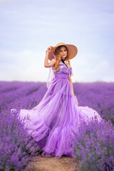 beautiful woman in a lush lilac dress in a field of lavender