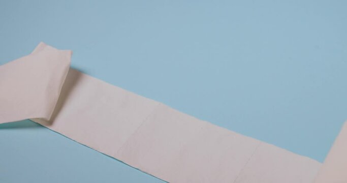toilet paper roll bouncing on blue background