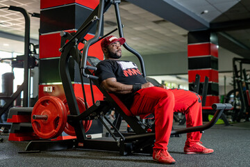 Guy working out in modern gym. Bodybuilding training in gym.