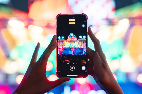 People holding smart phone and recording and photographing in music festival concert, party event background concept