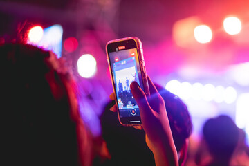 People holding smart phone and recording and photographing in music festival concert, event background concept