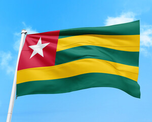 Togo flag fluttering in the wind on sky.