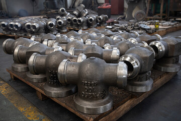 Warehouse of products from large water pipes and gas taps at a metal structures factory