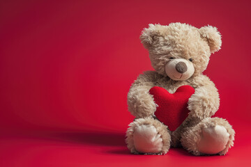a cute Valentine teddy bear holding a romantic red love heart against a red background