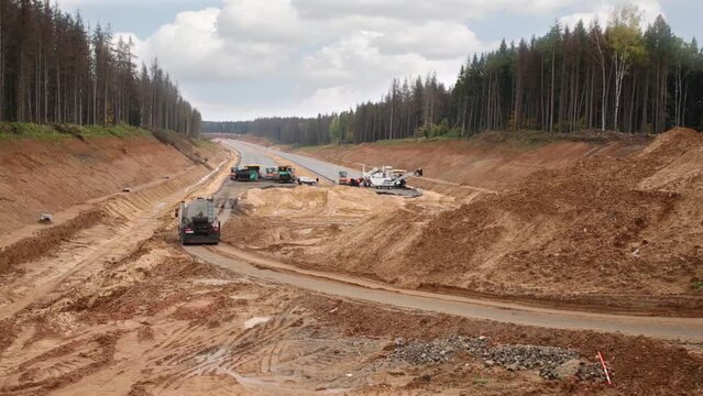 Truck moves to special road machinery in construction of highway