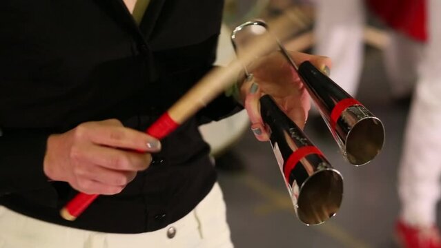 Female hands playing on percussion instruments on stage
