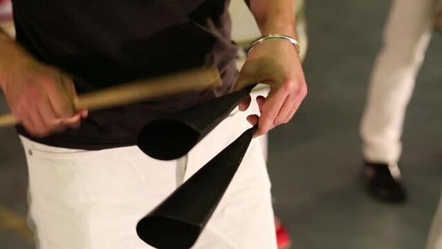 Male hands playing on percussion instruments on stage