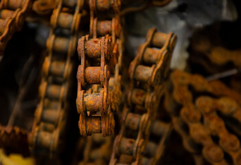 Backgrounds and textures: links of very old weathered rusty chain, close up shot, industrial abstract