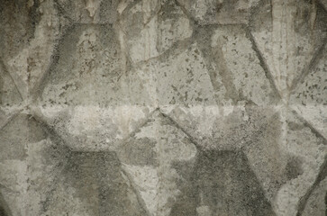 Pattern of grey volumetric texture made by casting wall ready for replicate on background. Unusual relief embossment . Concrete wall with traces of aging cracks, destruction and streaks
