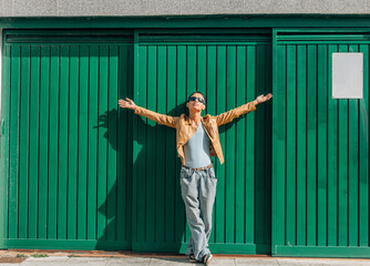 relaxed young man with open arms on the wall