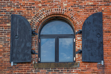Window on brick wall facade in Red Hook, Brooklyn, New York