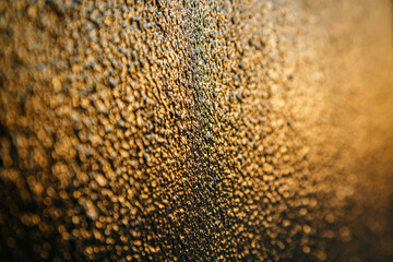 Black paint on metal hit by sunset reflection for background
