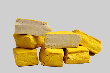 yellow tofu boxes stacked and isolated on white background. Foods high in vegetable protein are good for vegetarians.