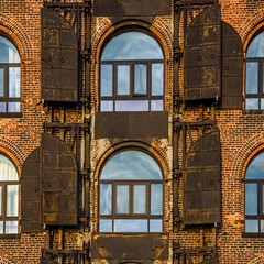 Detail of an old red bricks wall facade building in Red Hook, Brooklyn, New York
