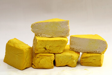 yellow tofu boxes stacked and isolated on white background. Foods high in vegetable protein are good for vegetarians.