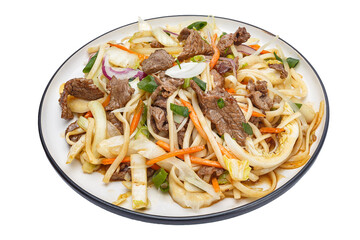 Vietnamese cuisine and food, udon noodles with vegetables and beef on a plate, on a white isolated background