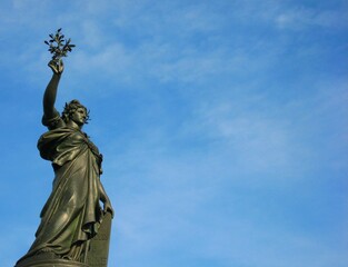 Fototapeta premium Marianne Statue at Place de la Republique under blue sky in Paris, France