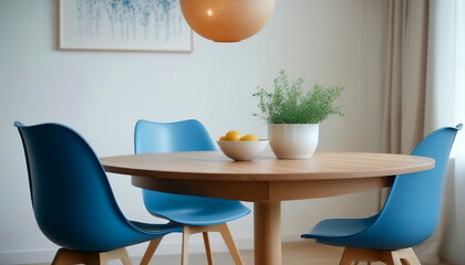 Round wooden dining table and blue chairs. Scandinavian, mid-century home interior design of modern dining room.