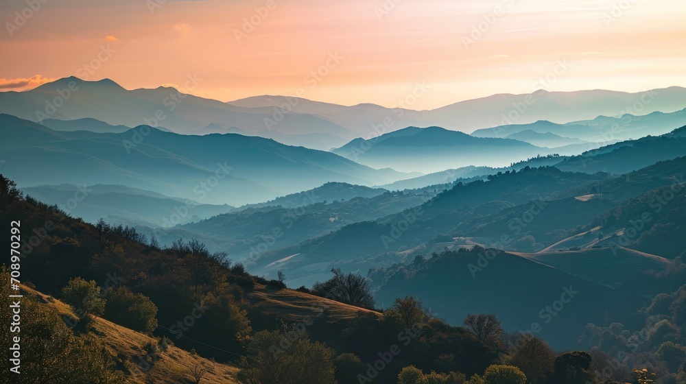 Poster a view of a mountain range with trees and mountains in the distance with a pink and blue sky in the 