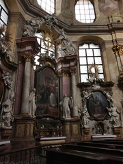 Side baroque altar with decorative religious columns, statues and paintings in Church Of Saint...