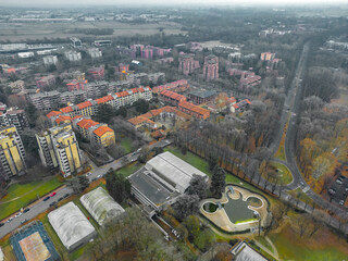Fototapeta na wymiar Cityscape aerial photography. Italian city view from a drone Sunset in cloudy weather, view from a drone of the city of San Donato Milanese, Milan, Italy