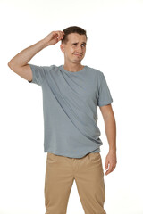 Young confused puzzled man isolated on white background