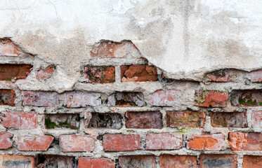 Close-up of old wall with brickwork under plaster