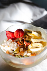 Homemade yogurt topped with sauce, fresh fruit and lots of grains.