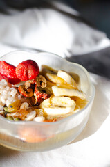 Homemade yogurt topped with sauce, fresh fruit and lots of grains.